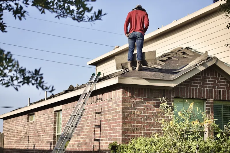 Professional roofer working on a residential roof in Dos Palos